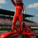 F1 Academy female driver in Prema Racing red and white suit celebrating a race win atop her Formula 4 car during a Grand Prix weekend.